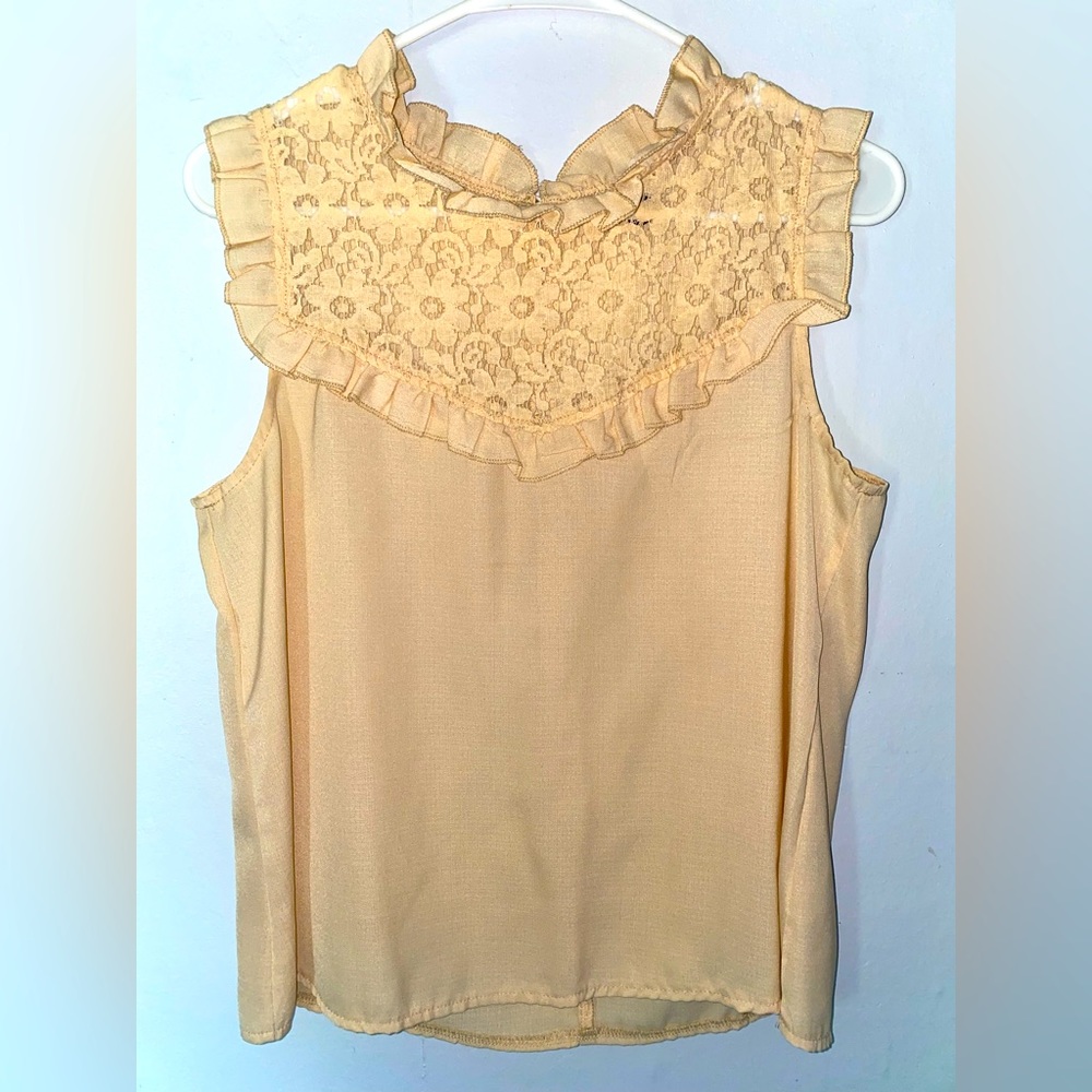 Women’s top. Size medium. Lacey flower embroidery on neck area. Lightly worn.